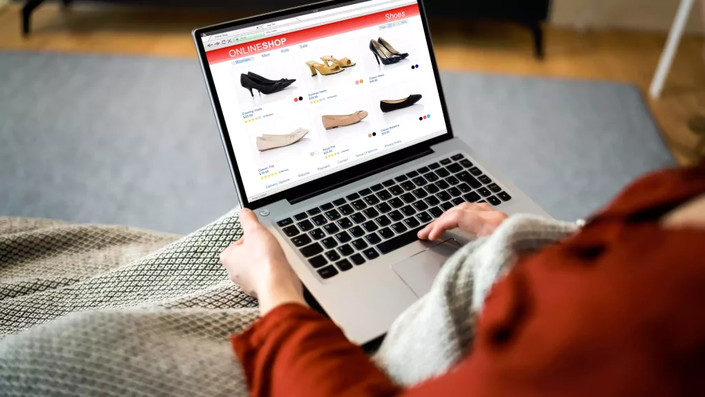 Woman shopping in ecommerce store on laptop