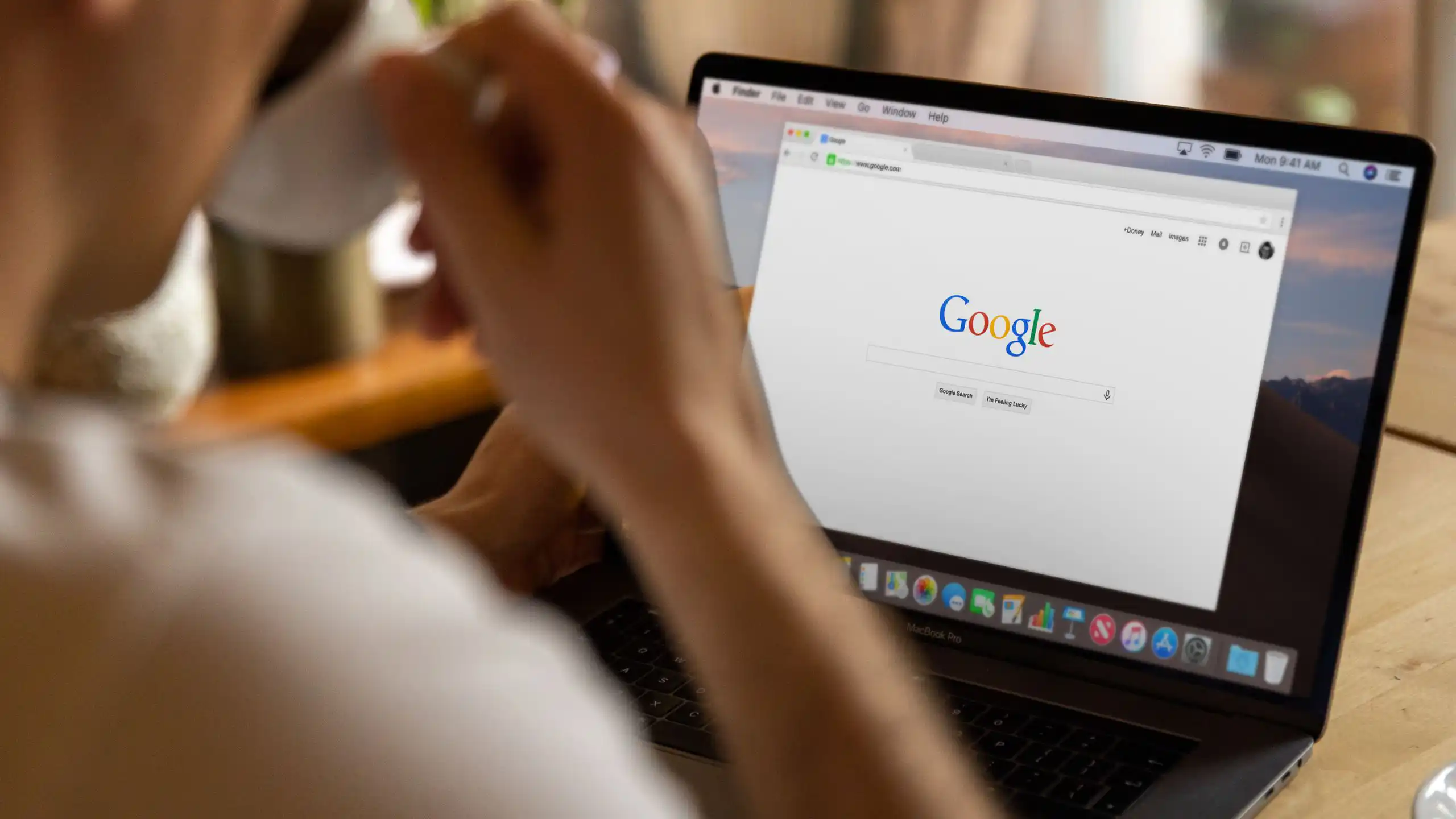 Making drinking coffee while looking at screen with Google search on it