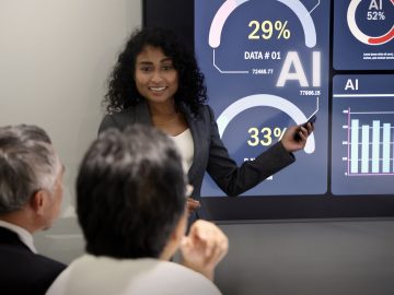 Woman showing team AI stats and results in conference room